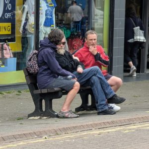 Kevin and Christine speaking to a man on a bench